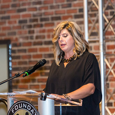 Woman Speaking at Podium
