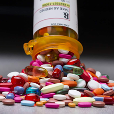 Pills Spilling out of Open Bottle