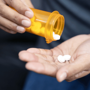 Pills spilling into hand