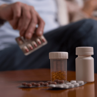 Hand Picking Up Pills