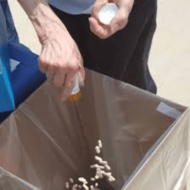 Pills being emptied into trash