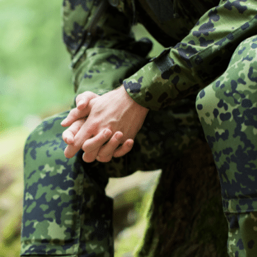 Service member with clasped hands