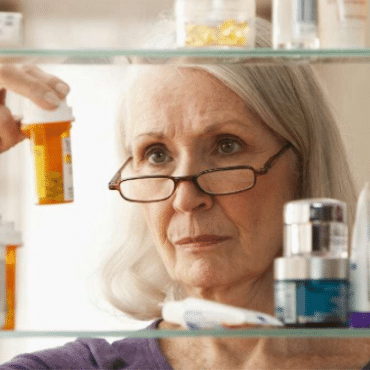 Woman looking at pill bottle
